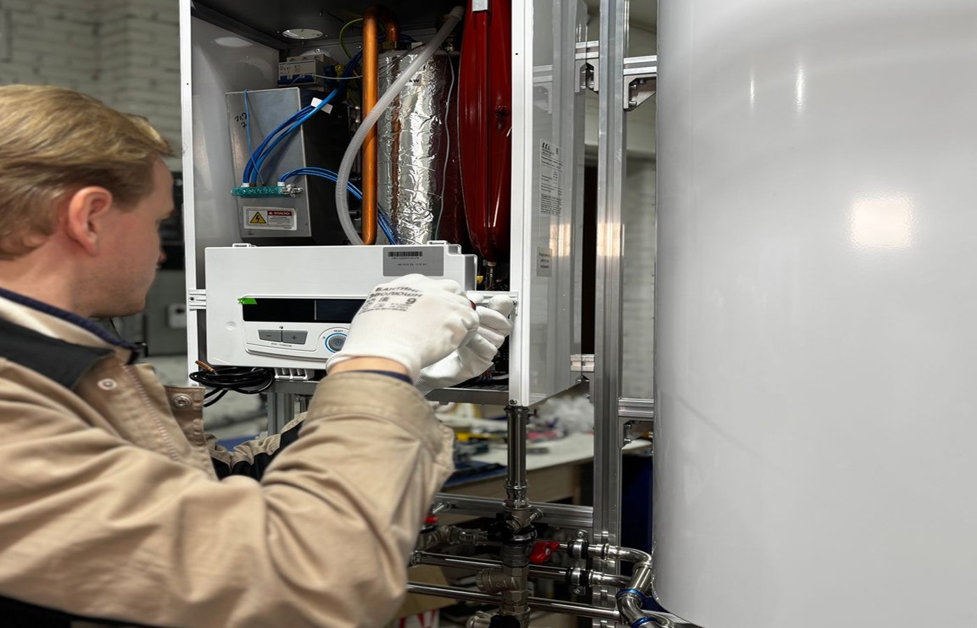 Engineer servicing an open domestic boiler