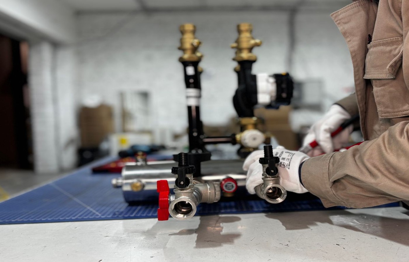 Heating engineer working on valves and pipework